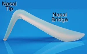 A silicone implant with labeled parts showing the nasal tip and nasal bridge against a blue background.