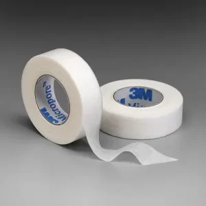 Two rolls of white 3M Micropore tape, one standing upright and the other lying flat with a length of tape extended.