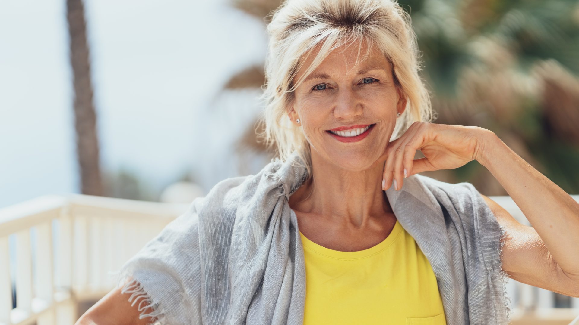 A smiling older woman with a refreshed, natural appearance &mdash; a typical brow lift candidate at Hilinski Facial Plastic Surgery in San Diego.