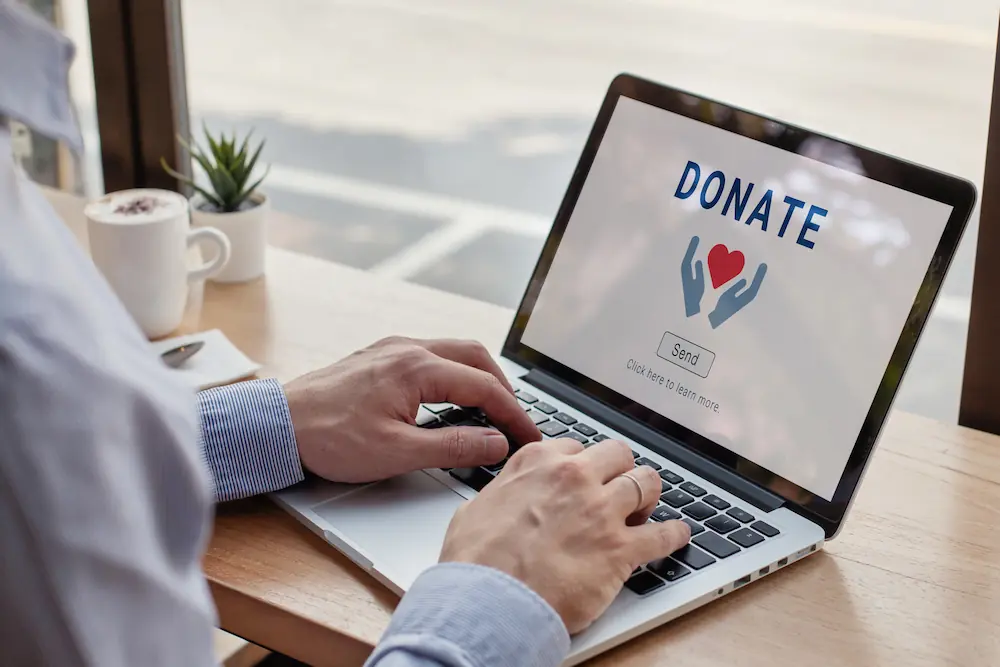 close up of person making a donation on a website